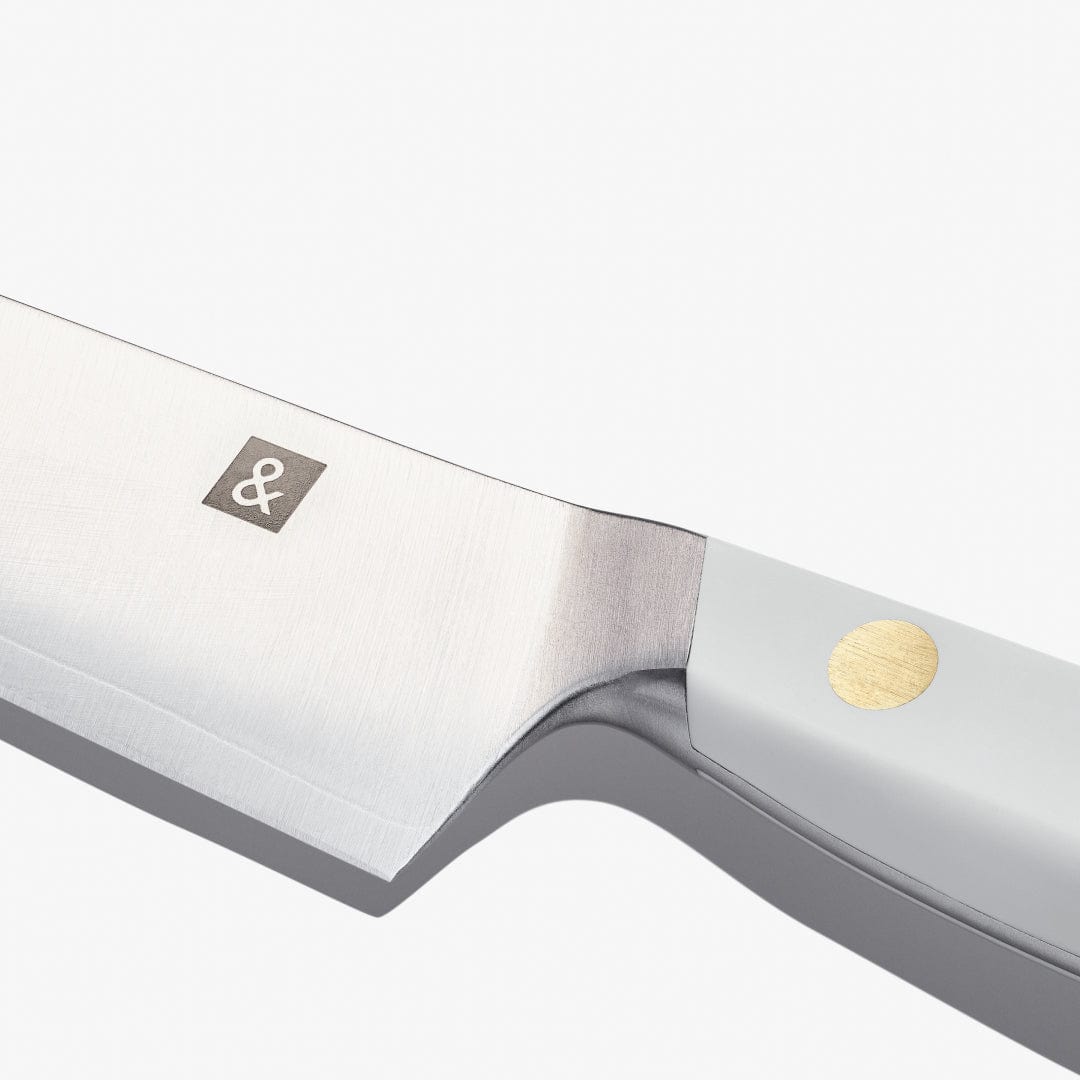 Close-up of the utility knife blade and white handle showing the maker's mark