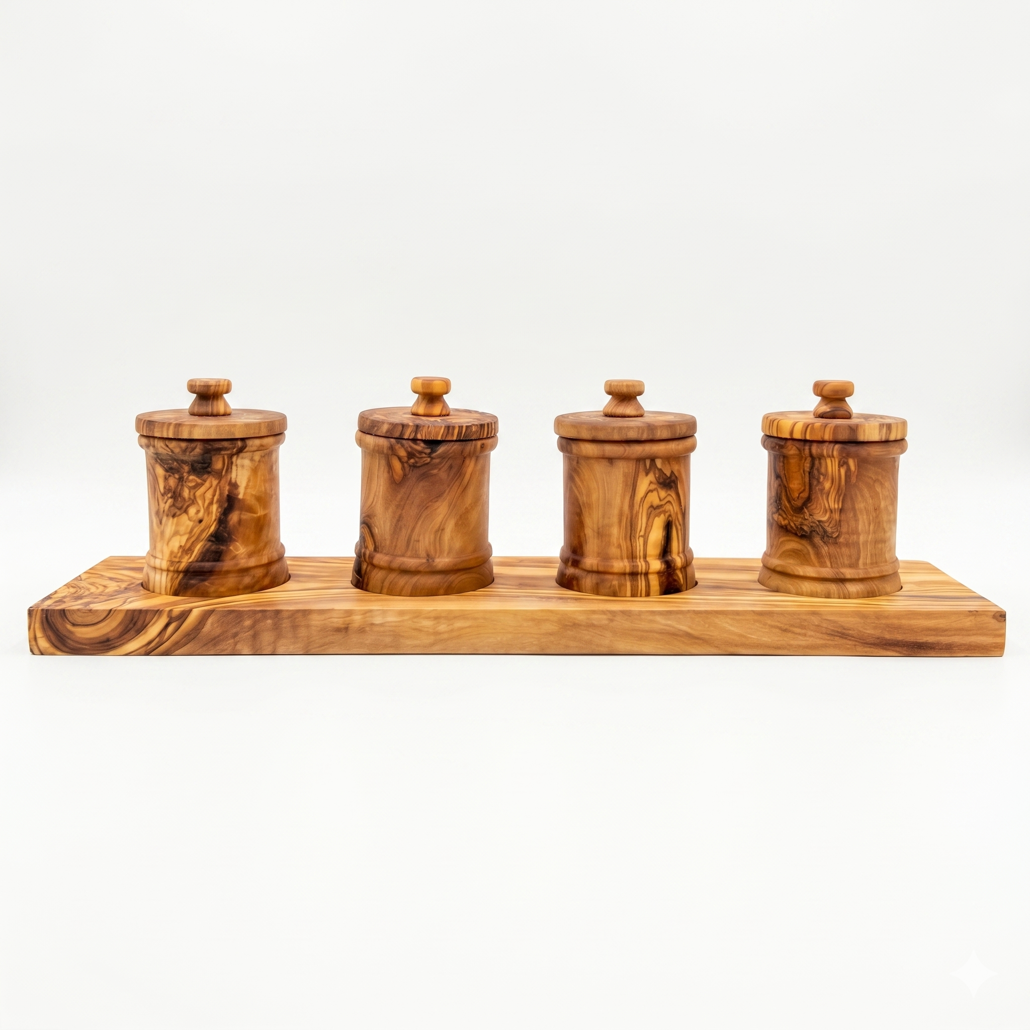 Four lidded olive wood canisters lined up on a long olive wood base against white