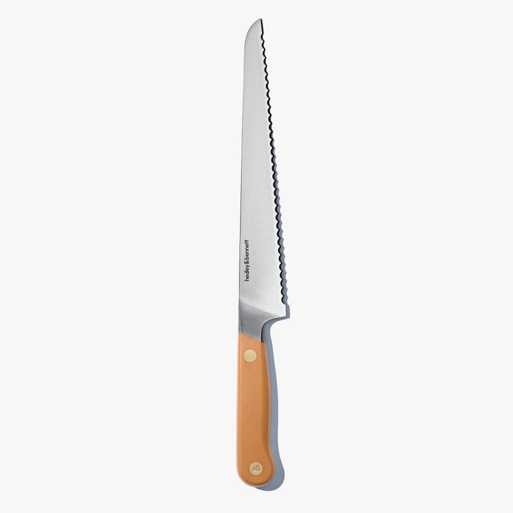 Bread knife with a tan handle, standing upright