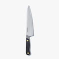 Chef's knife with a Caviar Black handle, standing upright