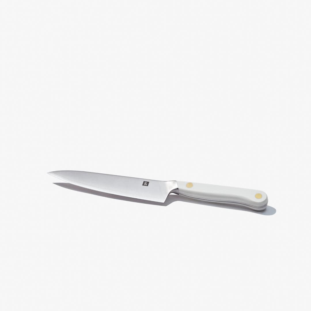 Utility knife laid flat, showing the full blade and white handle