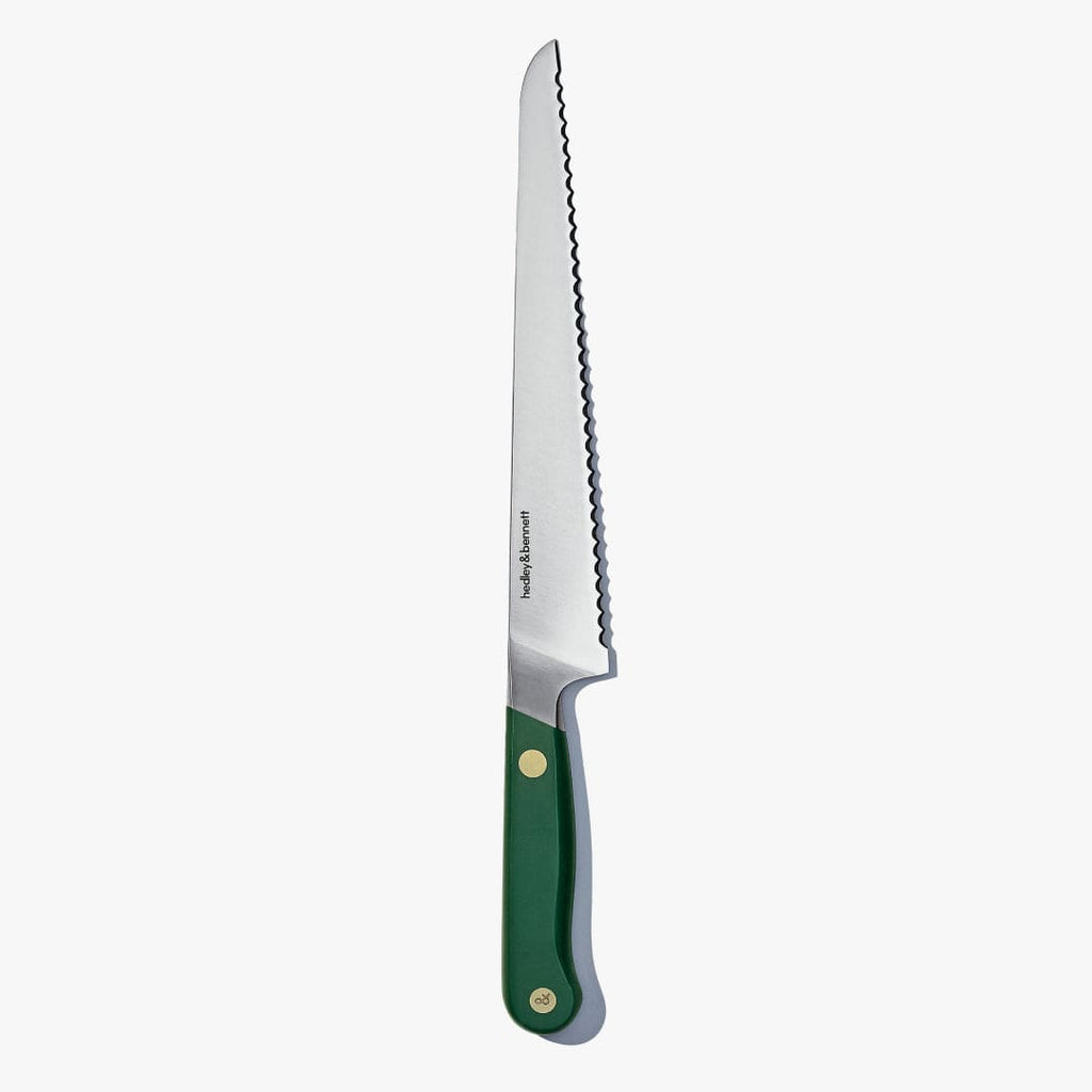 Bread knife with a Shiso Green handle, standing upright