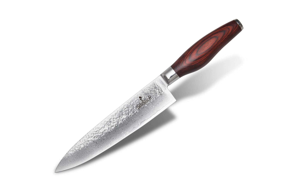 Damascus VG10 chef knife with hammered blade, angled with a soft shadow