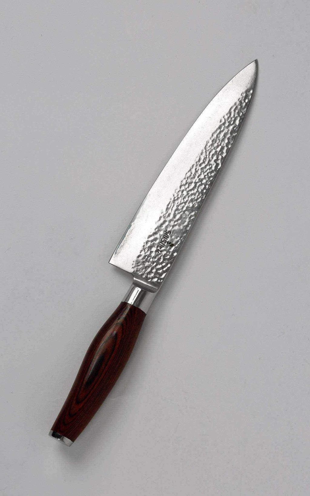 Damascus VG10 chef knife shown in full profile on a grey background