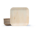 Square palm leaf plate propped against a nested stack of the same plates