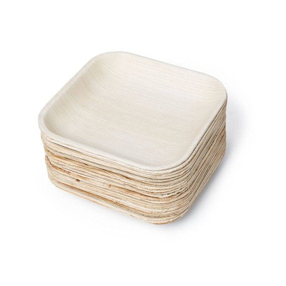 Stack of square palm leaf plates nested together