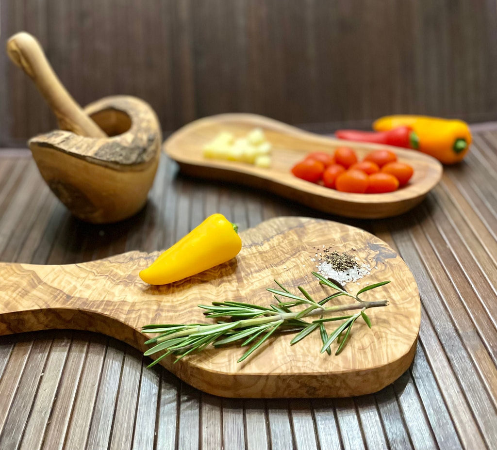 Olive wood set styled with cherry tomatoes, peppers, cheese and rosemary