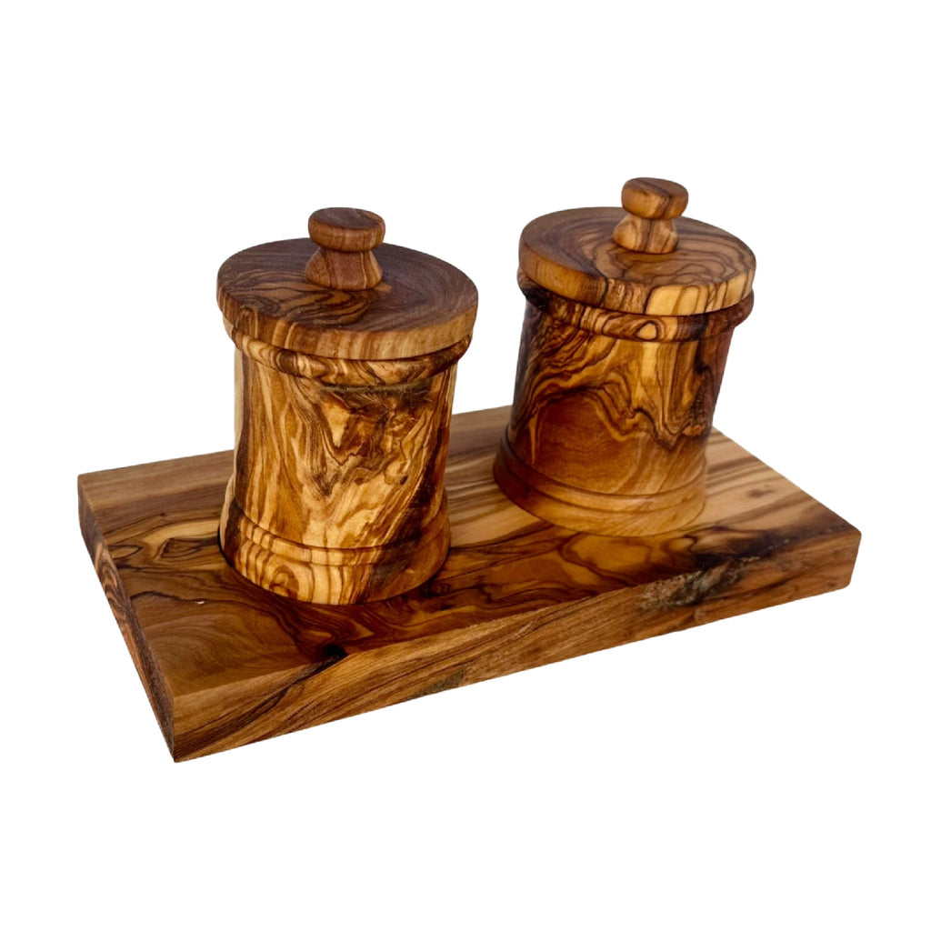 The two-canister olive wood set at a three-quarter angle against white