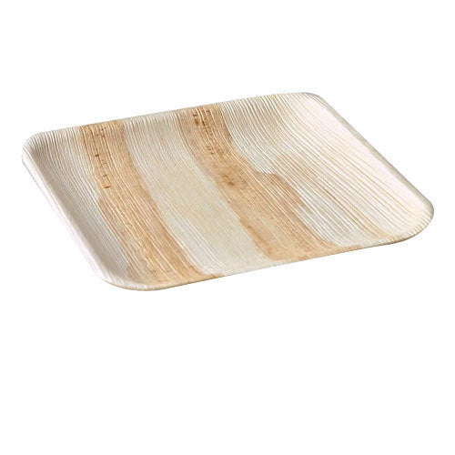 Empty square palm leaf plate at an angle against a white background