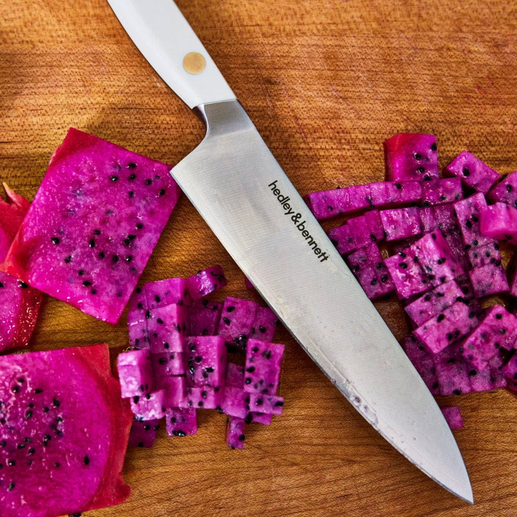 Utility knife on a wooden board with cubed dragon fruit
