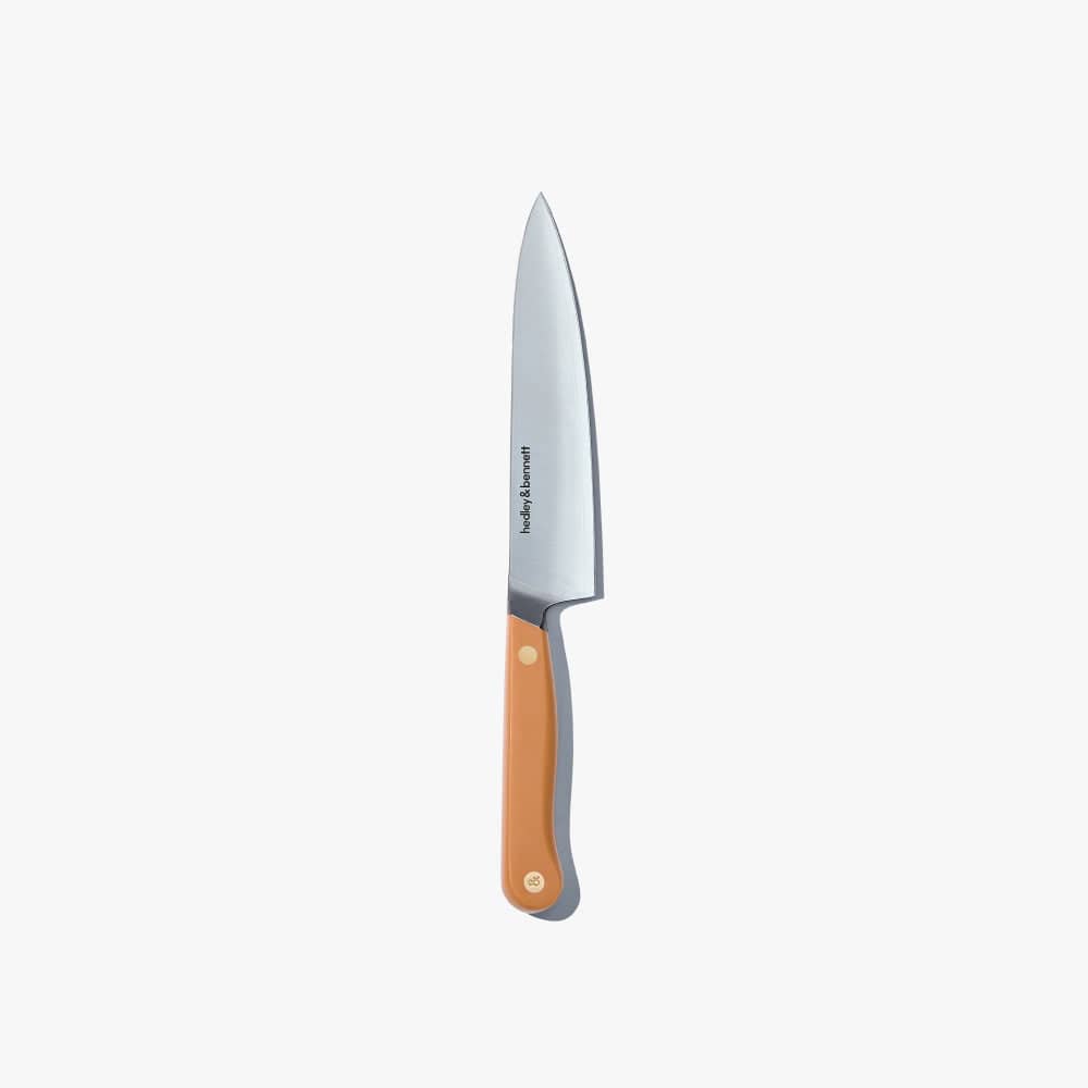 Utility knife with a tan handle, standing upright