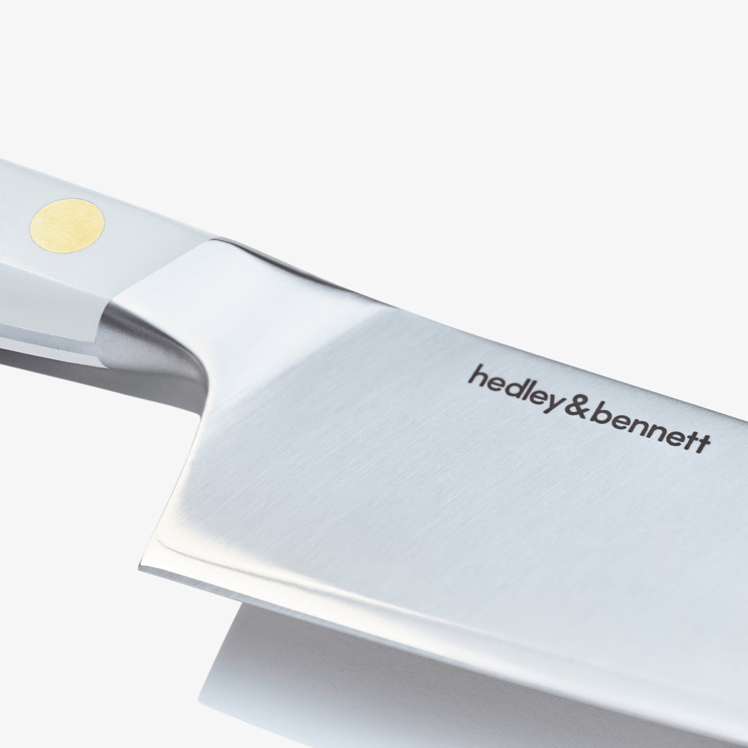 Close-up of the chef's knife blade showing the maker's mark