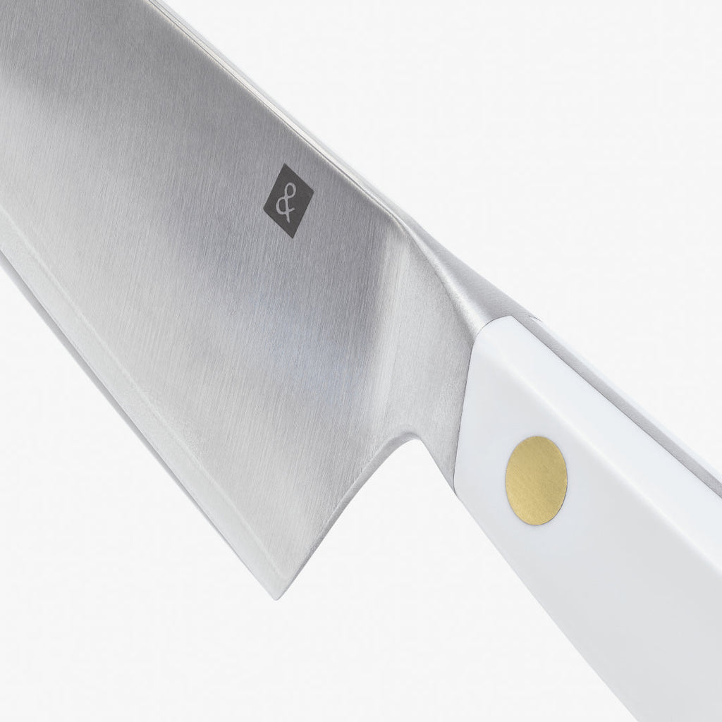 Close-up of the chef's knife blade heel and white handle