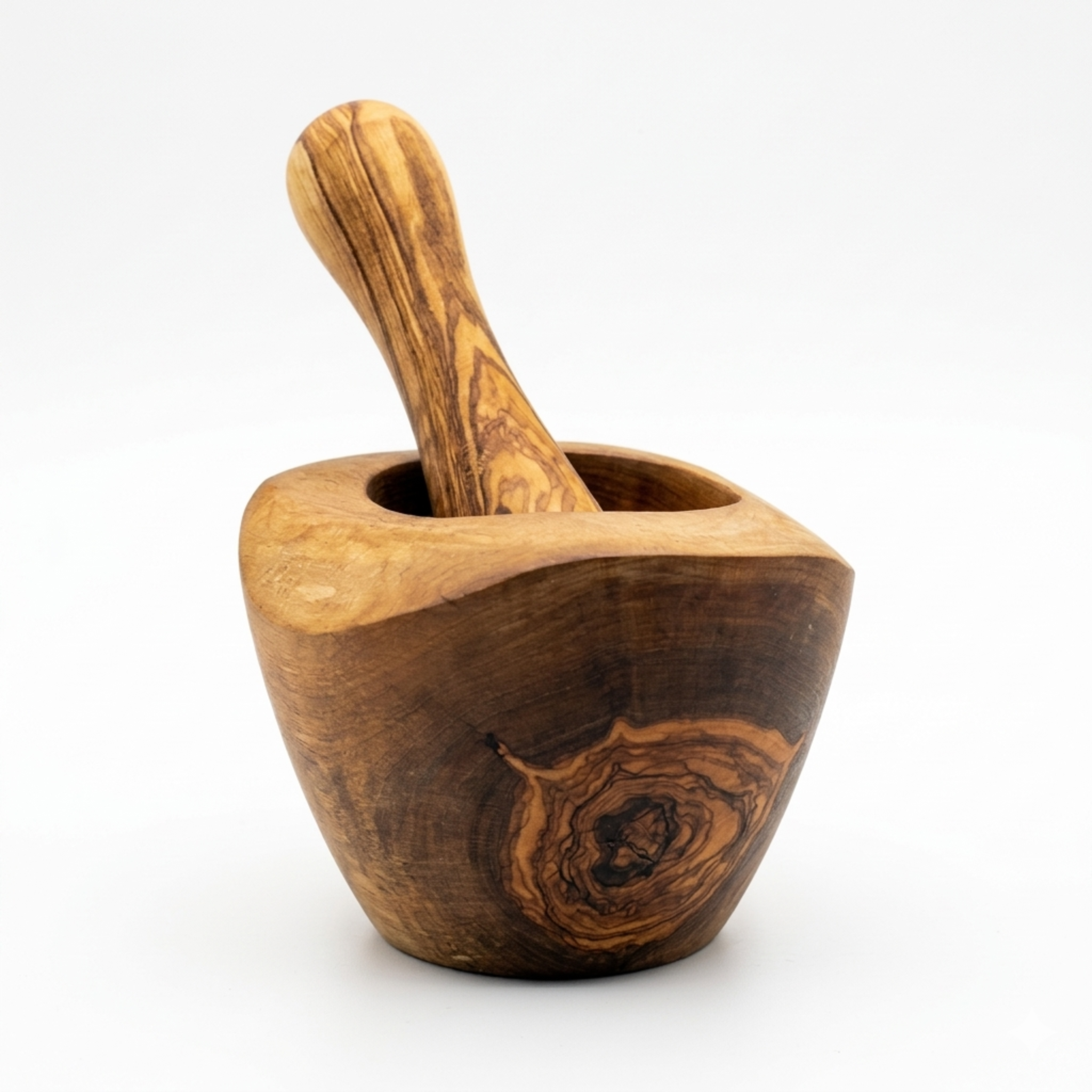 Olive wood mortar with its pestle resting inside, on a white background