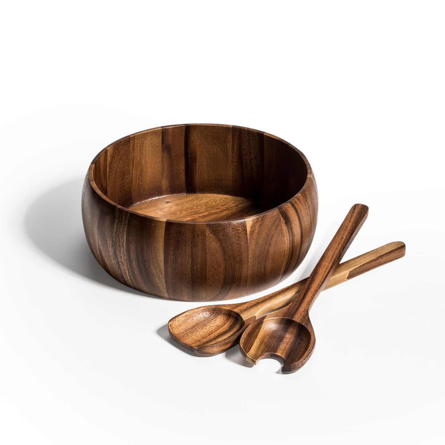 Large acacia salad bowl with two matching wooden servers on white