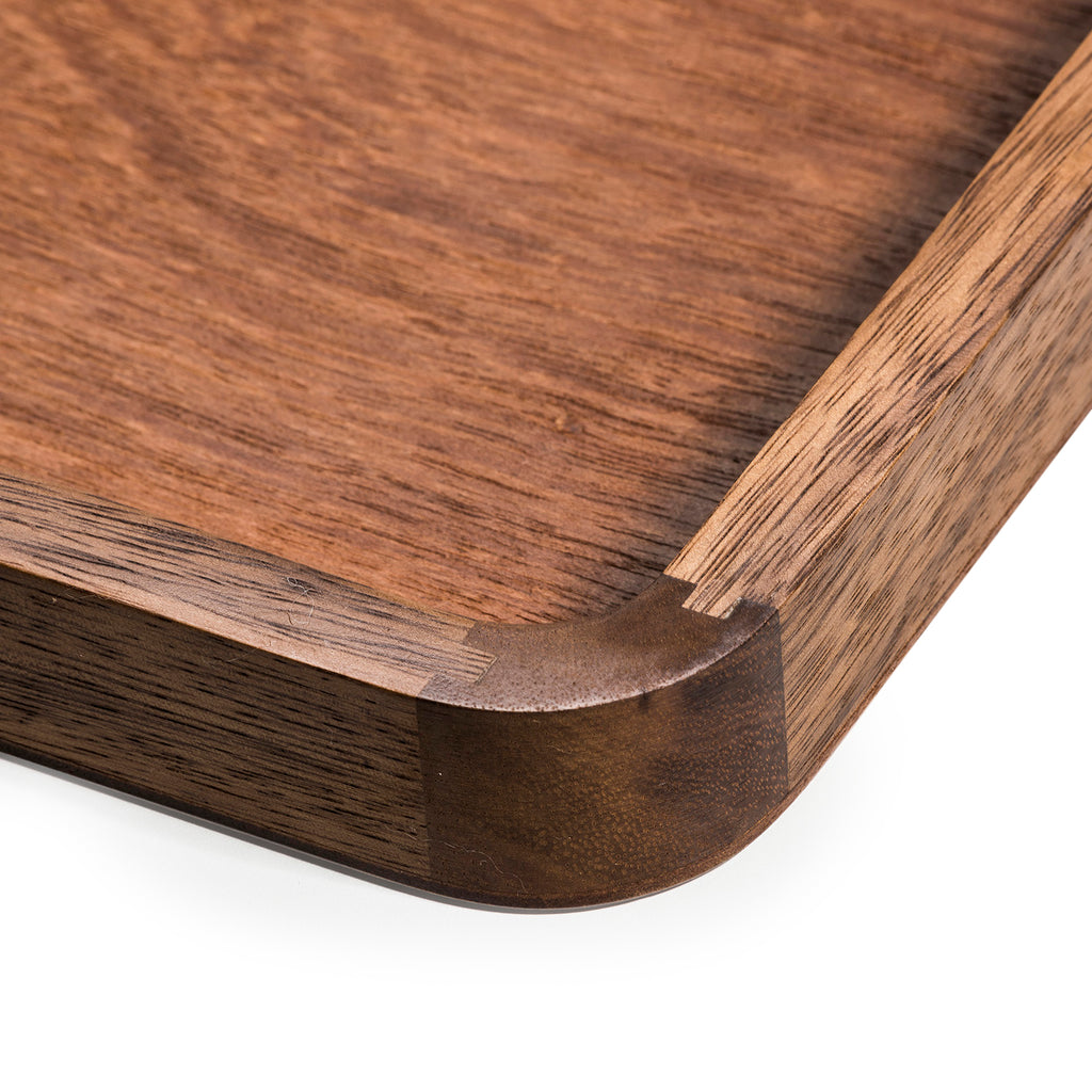 Close-up of the serving tray's corner joinery and raised lip